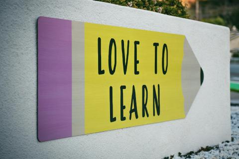 A mural featuring a pencil with the words "Love to Learn"